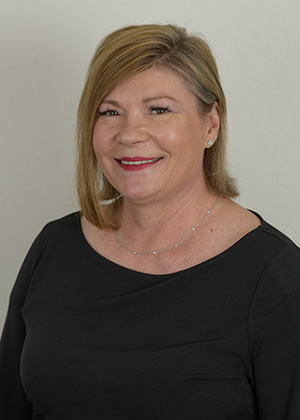 Staff photo of Jill S with light brown hair in a black blouse smiling at SS Orthodontics in Glendale and Phoenix, AZ