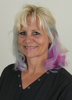 Staff photo of Jill with blonde hair with purple and blue streaks smiling at SS Orthodontics in Glendale and Phoenix, AZ