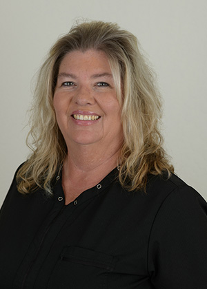 Staff photo of Lora with blonde layered hair wearing a black top smiling at SS Orthodontics in Glendale and Phoenix, AZ