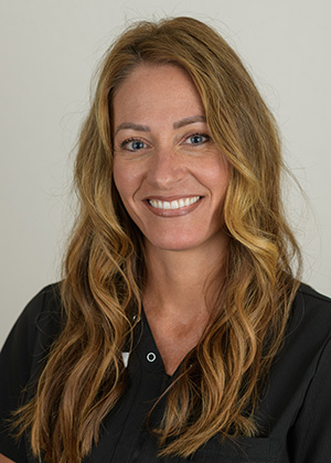 Staff photo of Rebekah with blonde wavy hair in a black top smiling at SS Orthodontics in Glendale and Phoenix, AZ