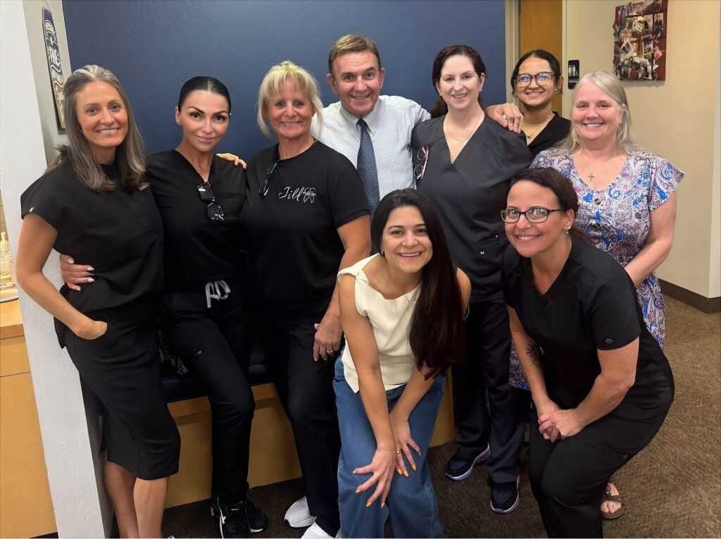 SS Orthodontics team smiling together inside the office in Phoenix & Glendale, AZ, welcoming patients for orthodontic care.
